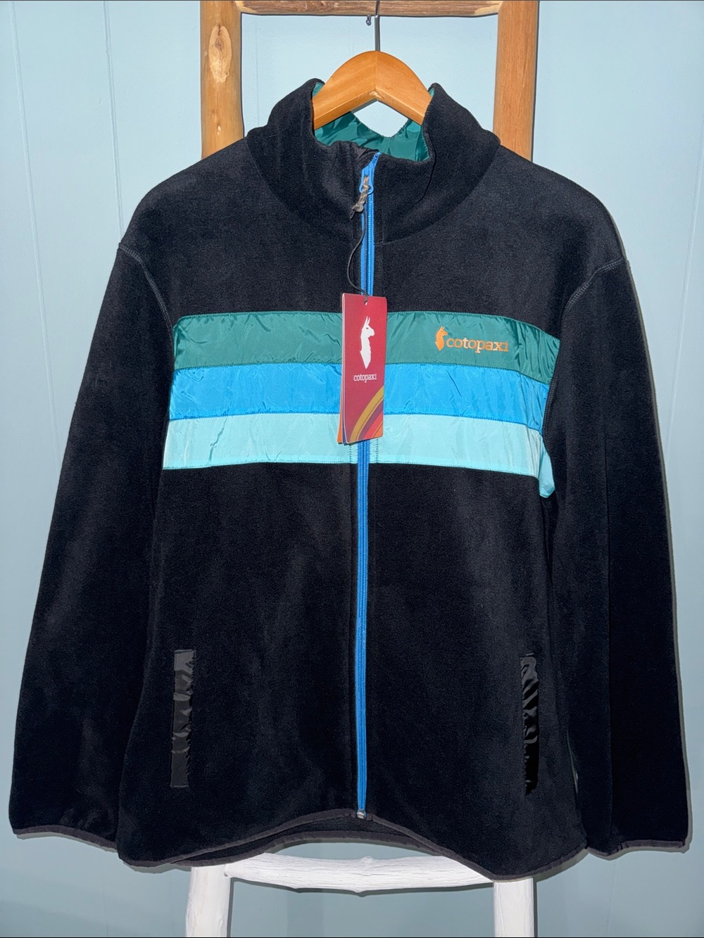 cotopaxi Black Fleece Jacket with Teal, Blue & Light Blue Stripes
